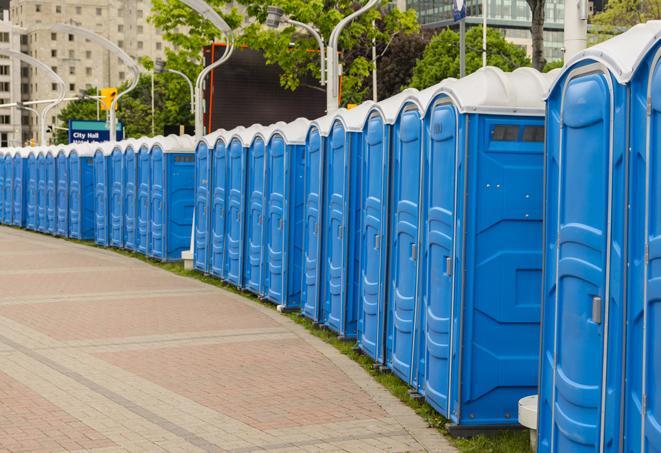 a line of portable restrooms at a sporting event, providing athletes and spectators with clean and accessible facilities in Haverhill